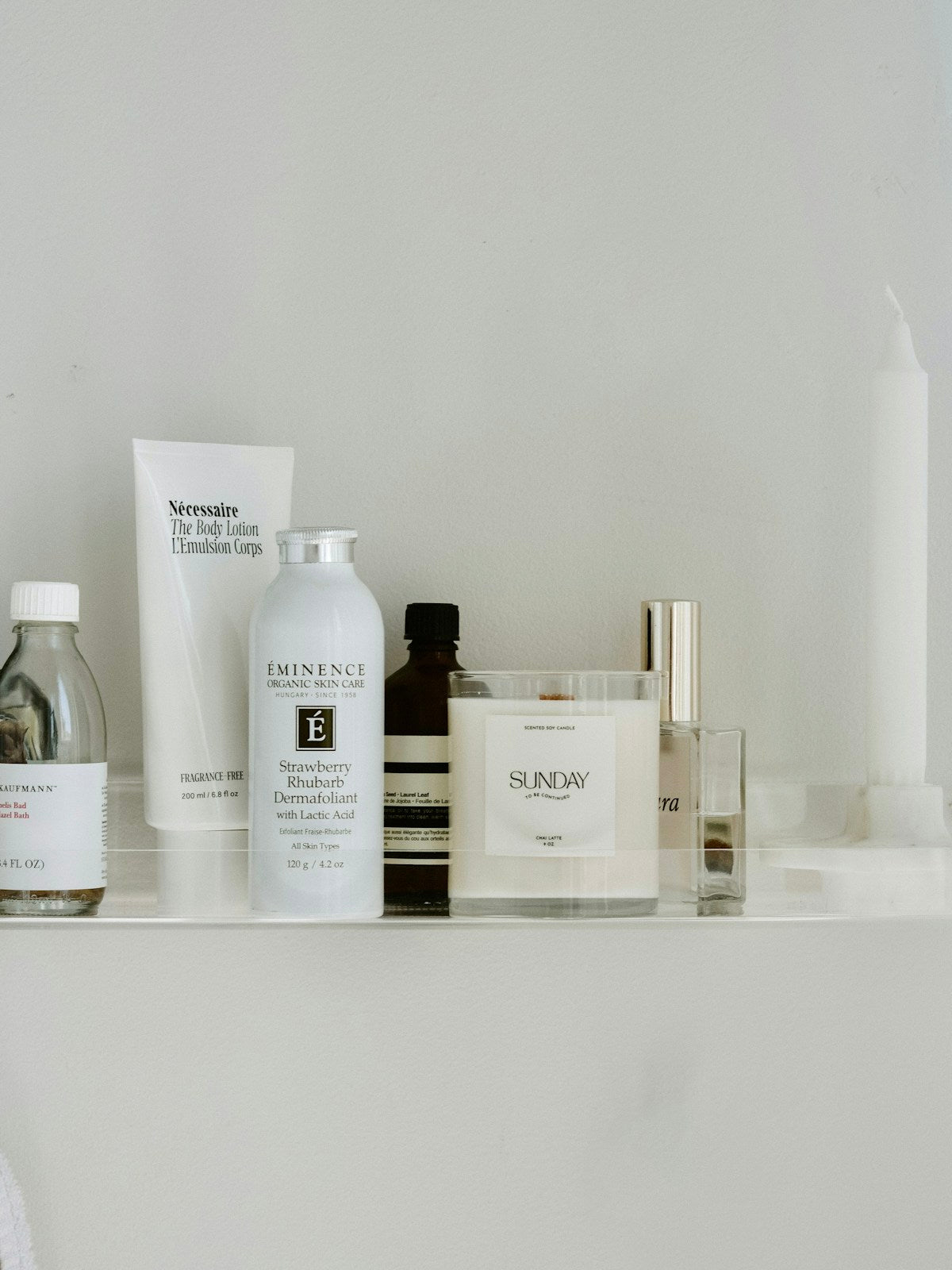 Several skincare and personal-care products arranged on a white shelf