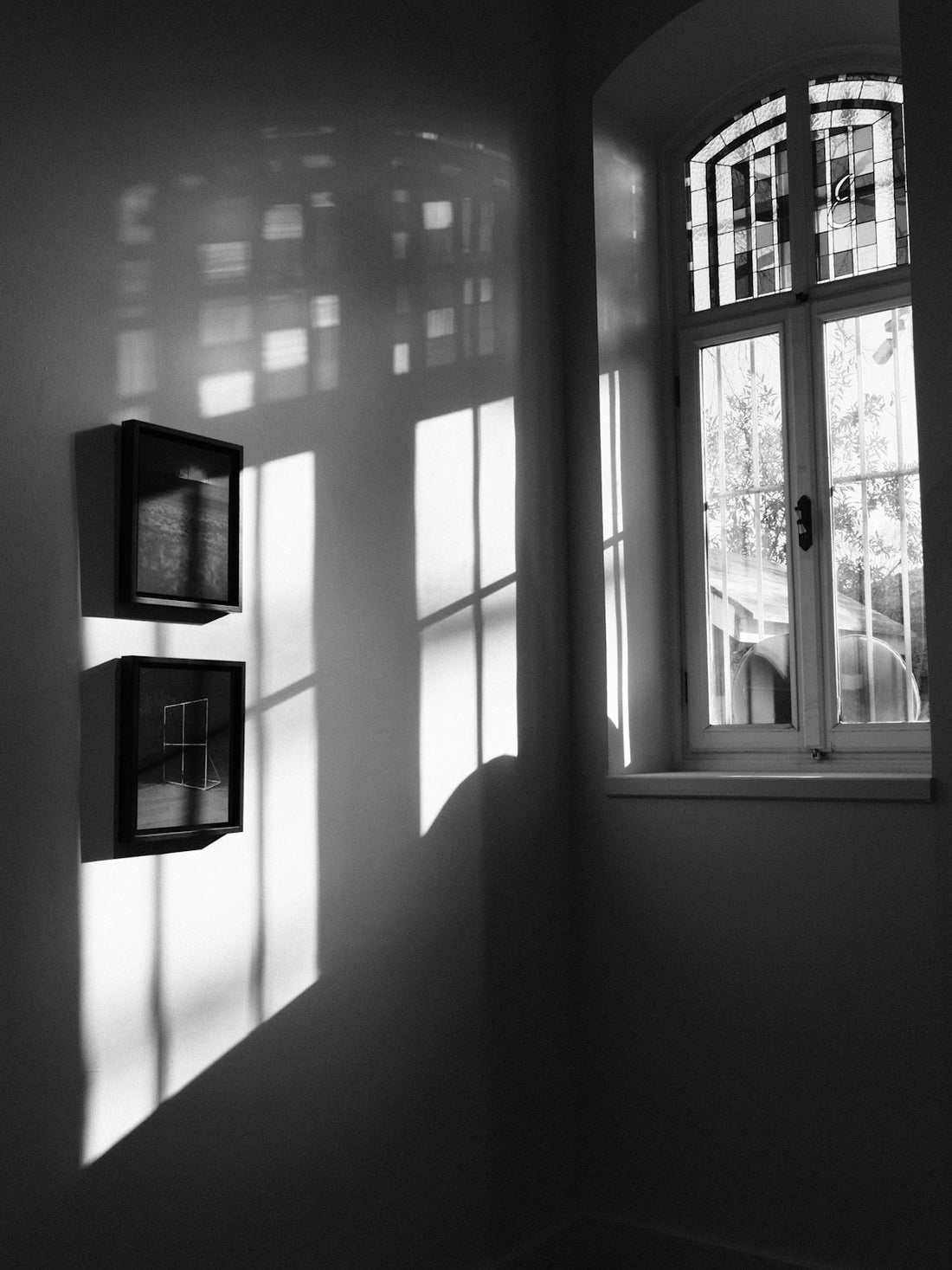 Window light falling across a pale wall